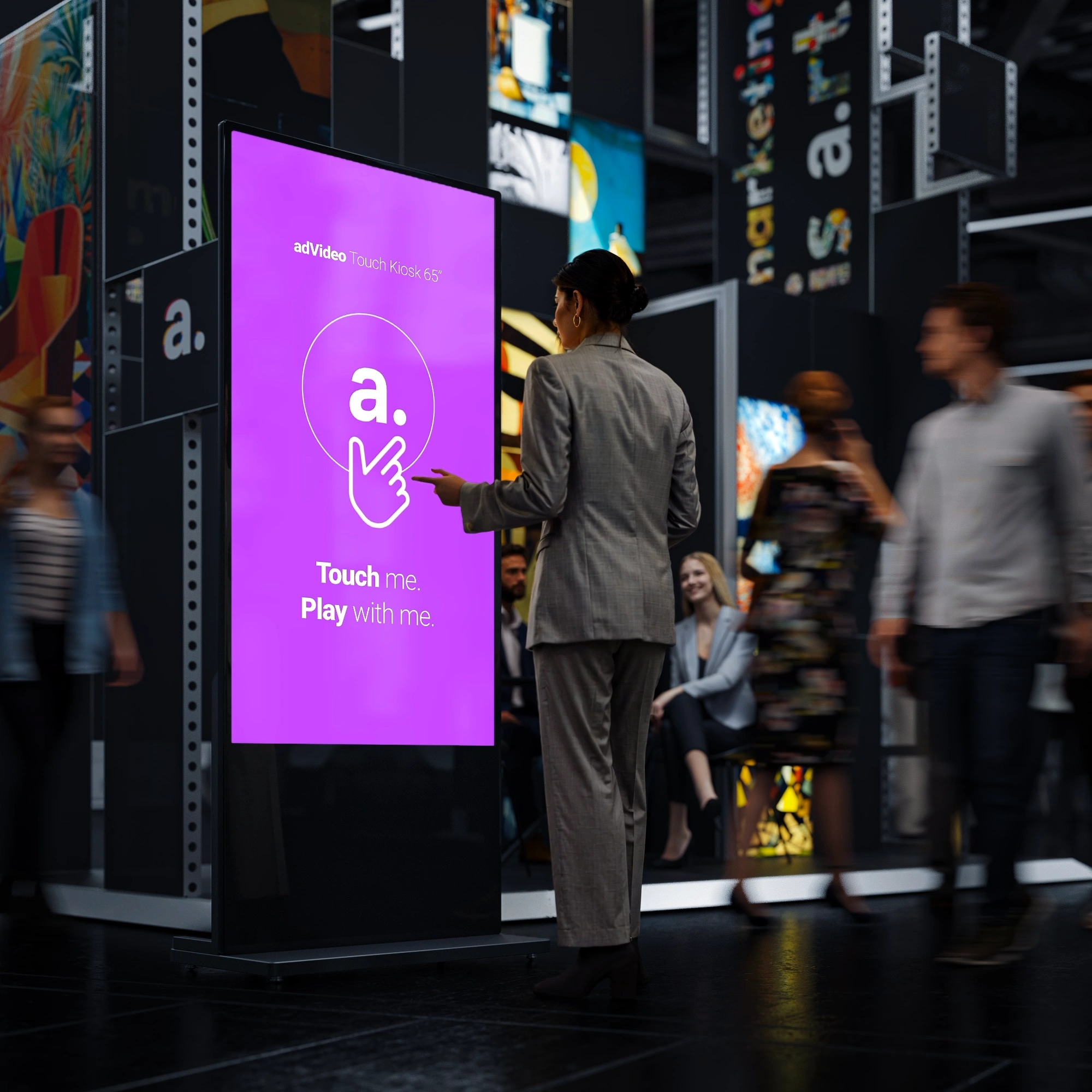 Uczestniczka wydarzenia obsługuje infokiosk dotykowy umieszczony w centralnej części hali.